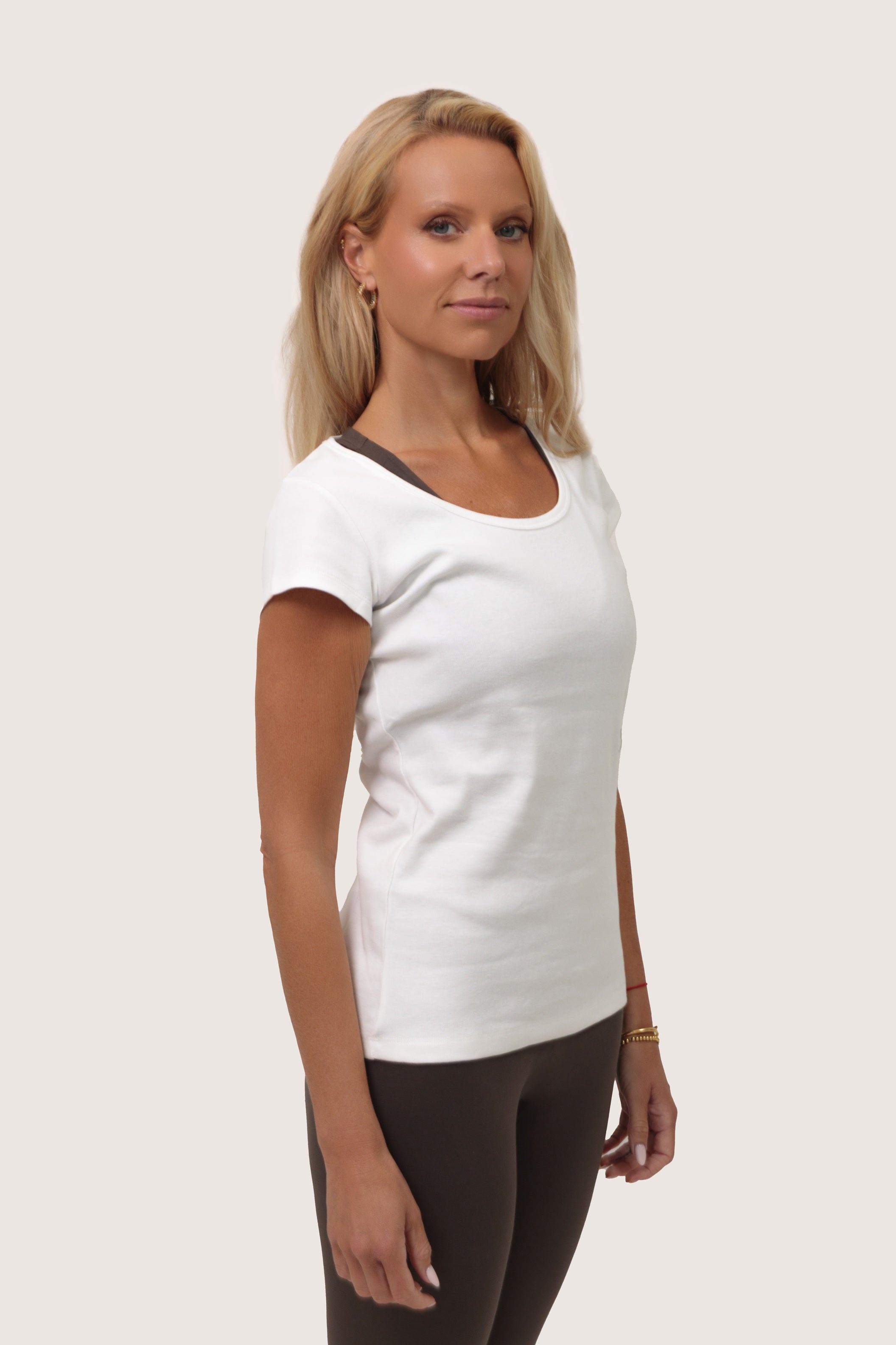Woman wearing a white t-shirt on a plain background