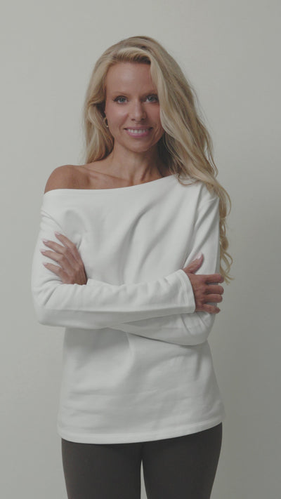 woman showing organic cotton white sweatshirt with assymmetric neckline and embroidered y logo 