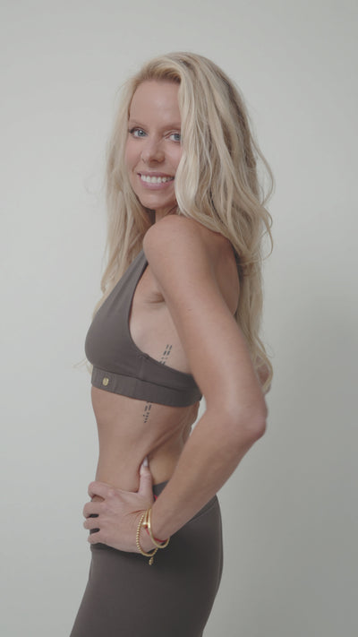 blonde woman showcasing a set of chocolate brown organic cotton lounge sportsbra and leggings 